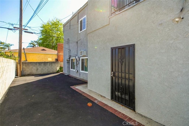 exterior space with stucco siding, a patio, and fence