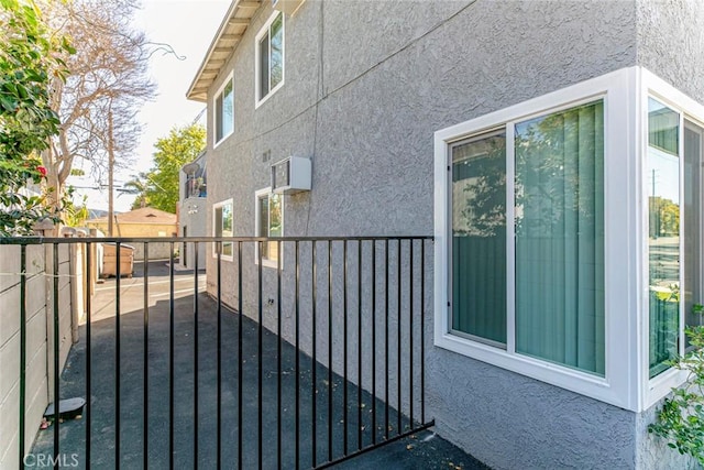 view of side of property with stucco siding and a fenced backyard