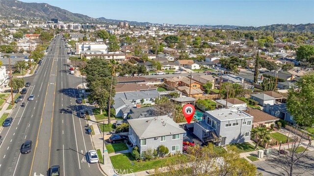 birds eye view of property featuring a mountain view and a residential view