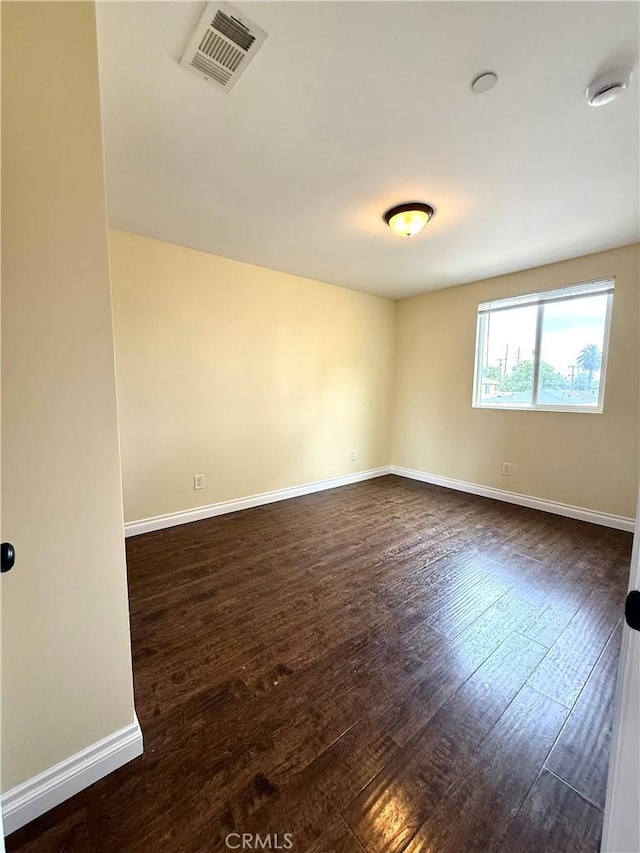 645 E 78th St, Los Angeles, CA 90001 - spare room with dark wood-type flooring and baseboards