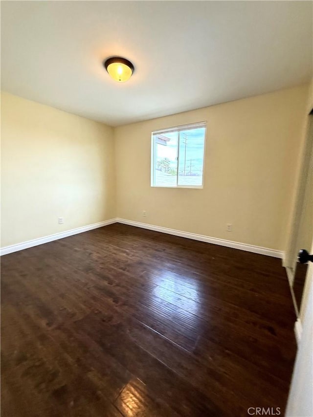 645 E 78th St, Los Angeles, CA 90001 - unfurnished room with dark wood-style floors and baseboards