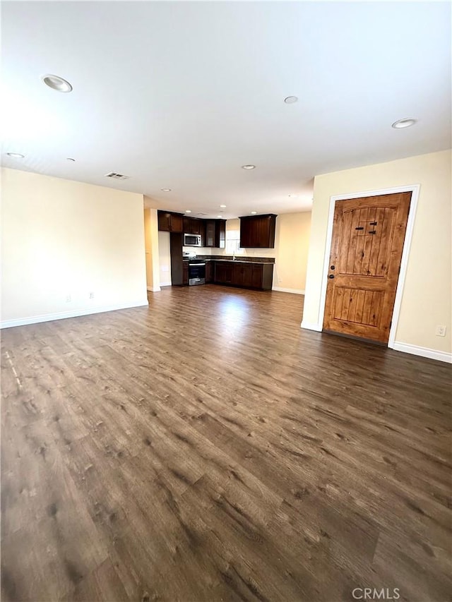 645 E 78th St, Los Angeles, CA 90001 - unfurnished living room with dark wood-style floors and recessed lighting