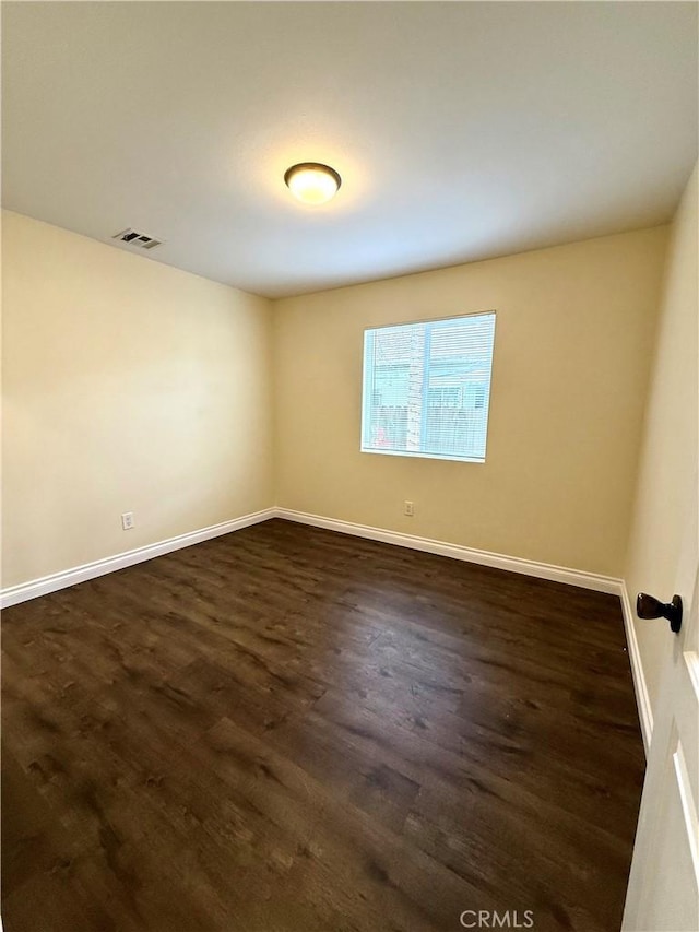 645 E 78th St, Los Angeles, CA 90001 - unfurnished room featuring dark wood-style flooring and baseboards