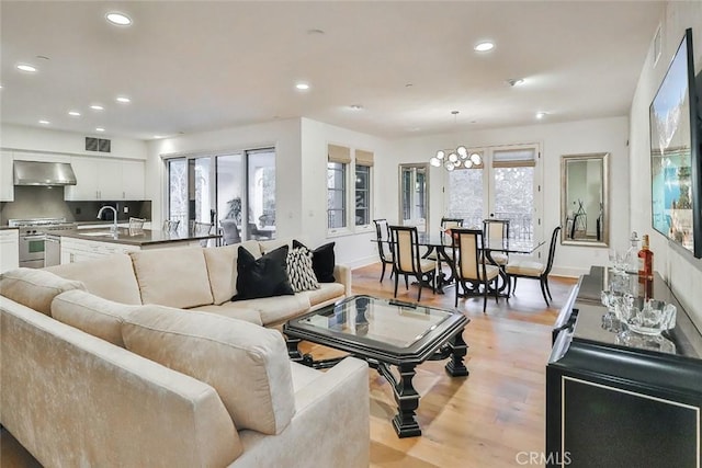 23500 Park Sorrento Unit D34, Calabasas, CA 91302 - living room with light wood-type flooring, recessed lighting, baseboards, and a chandelier