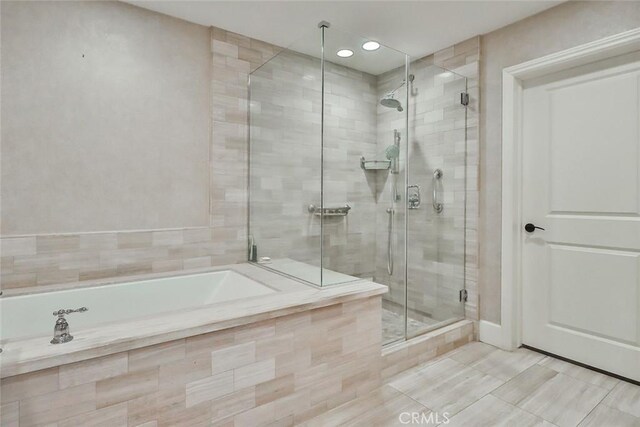 23500 Park Sorrento Unit D34, Calabasas, CA 91302 - bathroom featuring a shower stall, a garden tub, recessed lighting, and tile patterned floors