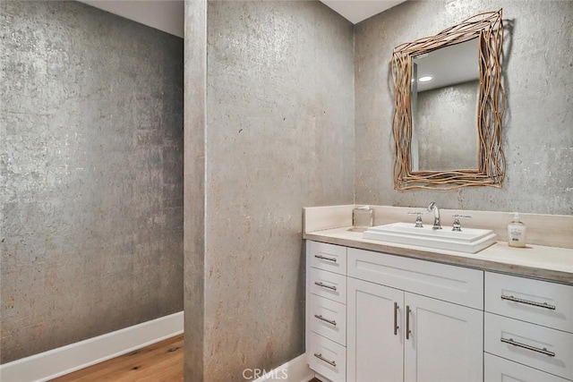 bathroom with wood finished floors and vanity
