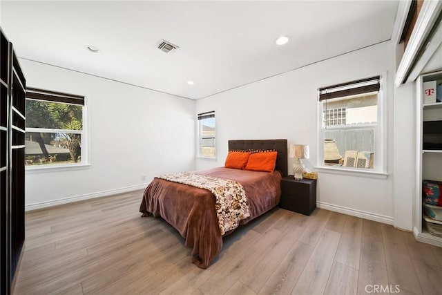 bedroom with light wood-style floors, baseboards, visible vents, and recessed lighting