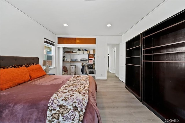 bedroom featuring baseboards, recessed lighting, and wood finished floors