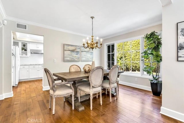 33972 Cape Cv, Dana Point, CA 92629 - dining room with wood-type flooring, a chandelier, and ornamental molding