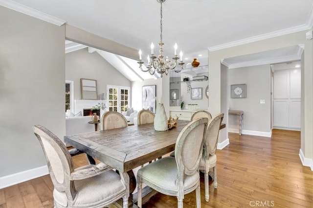 33972 Cape Cv, Dana Point, CA 92629 - dining room with a chandelier, vaulted ceiling with beams, light wood-type flooring, and baseboards