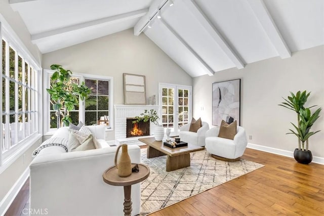 33972 Cape Cv, Dana Point, CA 92629 - living area with a wealth of natural light, beamed ceiling, wood-type flooring, and a brick fireplace