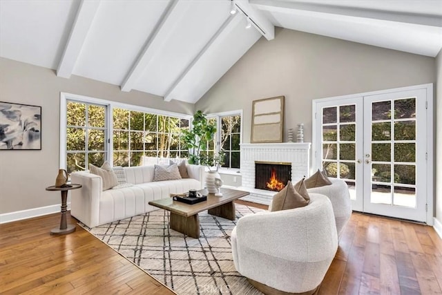 33972 Cape Cv, Dana Point, CA 92629 - living area featuring a wealth of natural light, beamed ceiling, hardwood / wood-style flooring, french doors, and baseboards