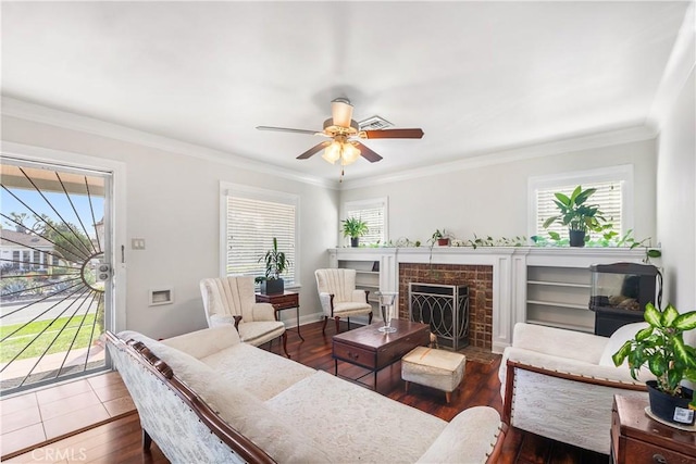 living room with crown molding, a ceiling fan, and a wealth of natural light