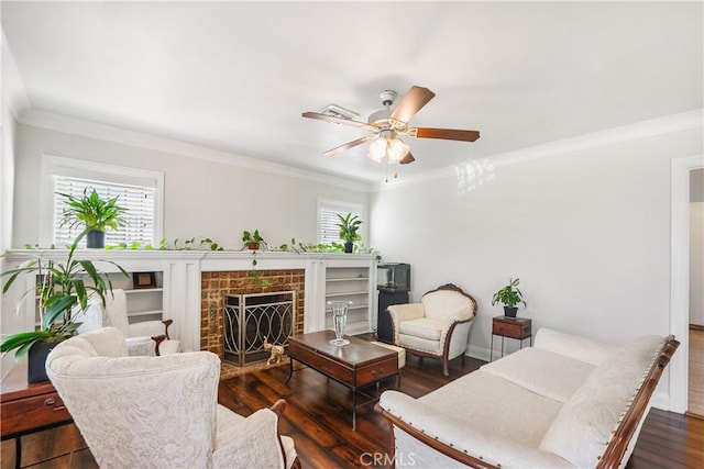living room with dark wood-type flooring, baseboards, ceiling fan, ornamental molding, and a fireplace