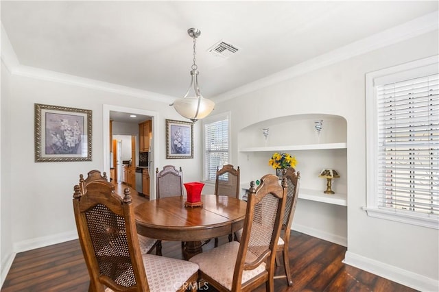 dining area featuring dark wood-style floors, visible vents, baseboards, and a wealth of natural light