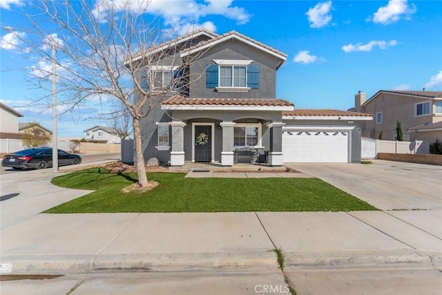 mediterranean / spanish house with fence, driveway, stucco siding, a garage, and a tile roof