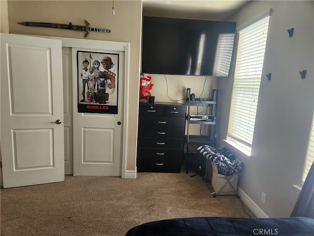 carpeted bedroom with baseboards