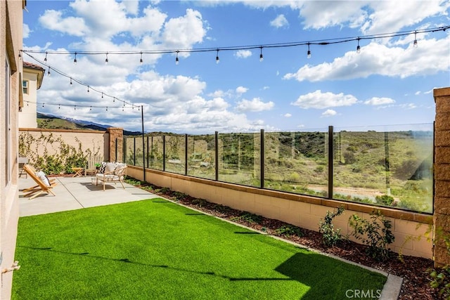 view of yard featuring a patio area and fence