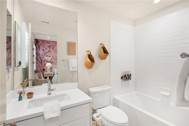 ensuite bathroom featuring visible vents, toilet, connected bathroom, tub / shower combination, and vanity