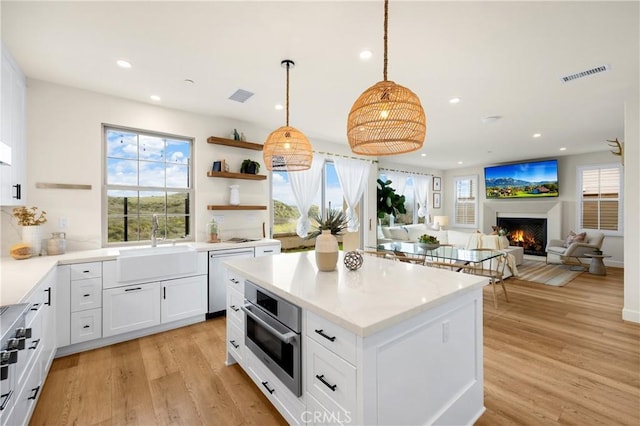 kitchen featuring light wood finished floors, visible vents, and appliances with stainless steel finishes