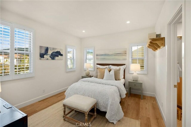 bedroom featuring recessed lighting, wood finished floors, and baseboards