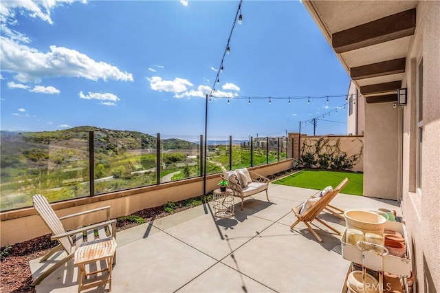 view of patio with a fenced backyard and a mountain view