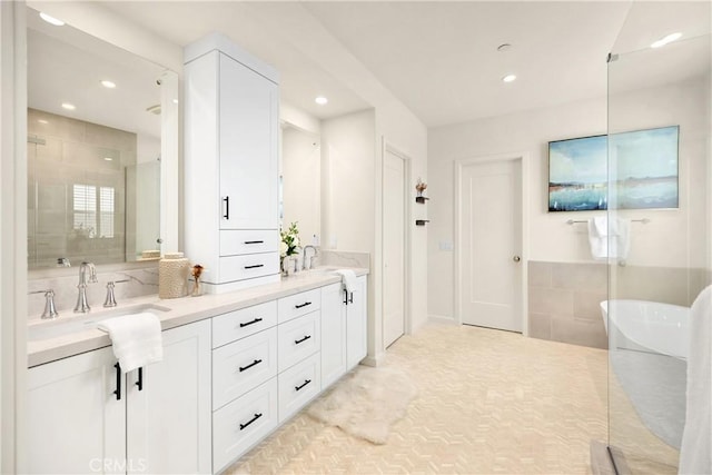 full bathroom with a sink, double vanity, recessed lighting, and a shower stall