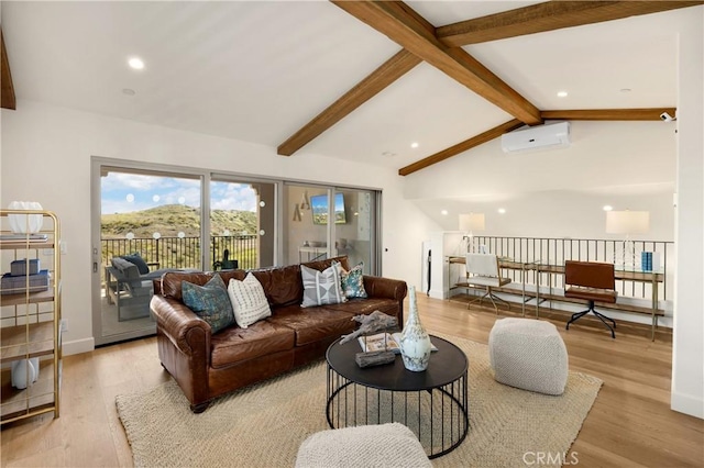 living area with a wall unit AC, vaulted ceiling with beams, wood finished floors, and baseboards