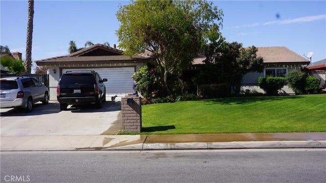 ranch-style home with an attached garage, concrete driveway, and a front yard