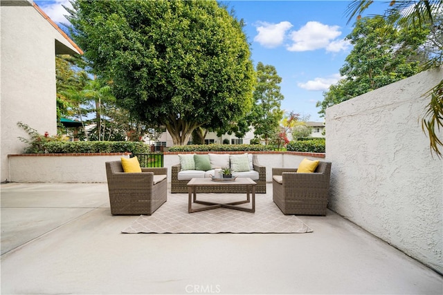 view of patio featuring an outdoor hangout area and fence