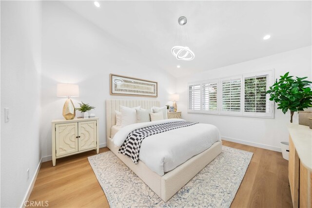 bedroom featuring recessed lighting, light wood-type flooring, and lofted ceiling