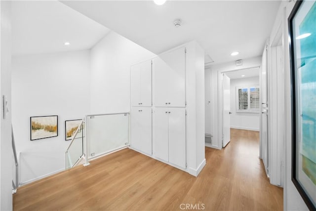 corridor with visible vents, recessed lighting, light wood-type flooring, and baseboards