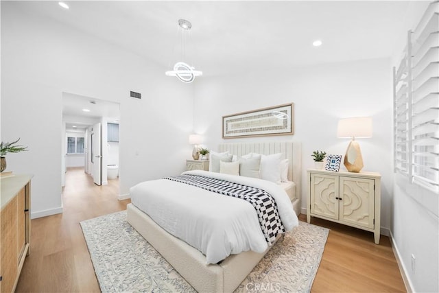 bedroom featuring light wood-type flooring, visible vents, a notable chandelier, recessed lighting, and baseboards