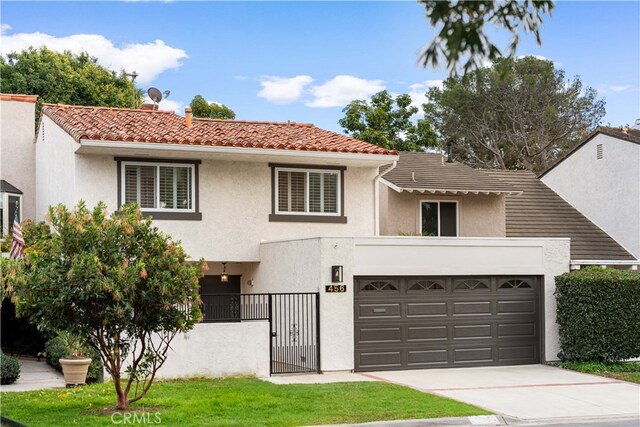 view of front of house featuring fence, driveway, stucco siding, a garage, and a tile roof