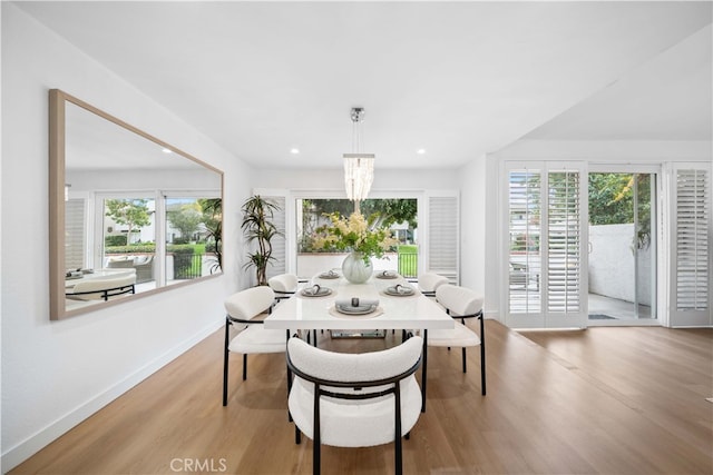 dining room with recessed lighting, light wood-type flooring, and baseboards