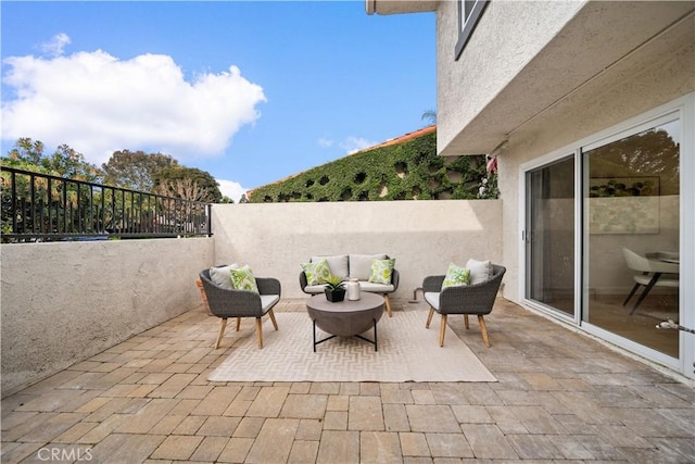 view of patio / terrace featuring an outdoor living space and a fenced backyard