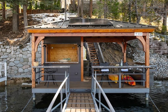 exterior space featuring a water view and fence