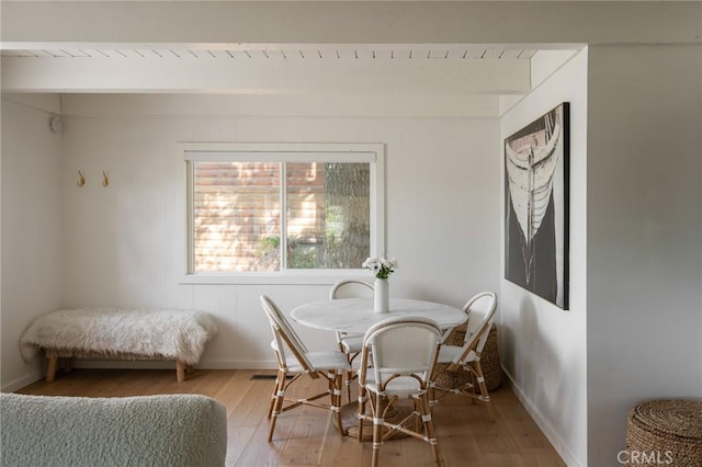 dining room featuring hardwood / wood-style flooring and baseboards
