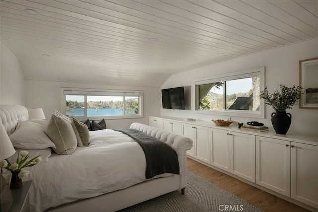 bedroom with light wood-style flooring, wood ceiling, and vaulted ceiling