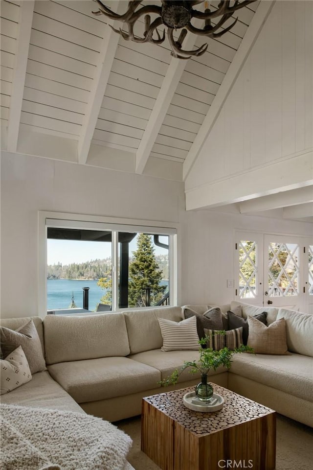 living room featuring high vaulted ceiling, beam ceiling, and a water view