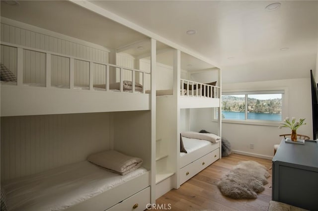 bedroom with baseboards and wood finished floors