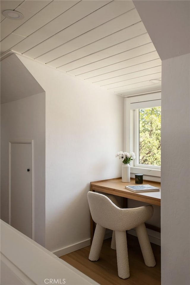 dining room with wood ceiling, baseboards, and wood finished floors