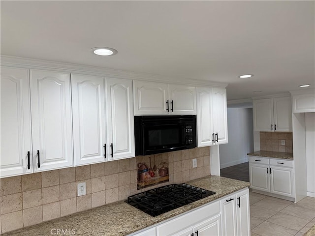 2440 Amelgado Dr, Hacienda Heights, CA 91745 - kitchen with light stone counters, white cabinetry, and black appliances