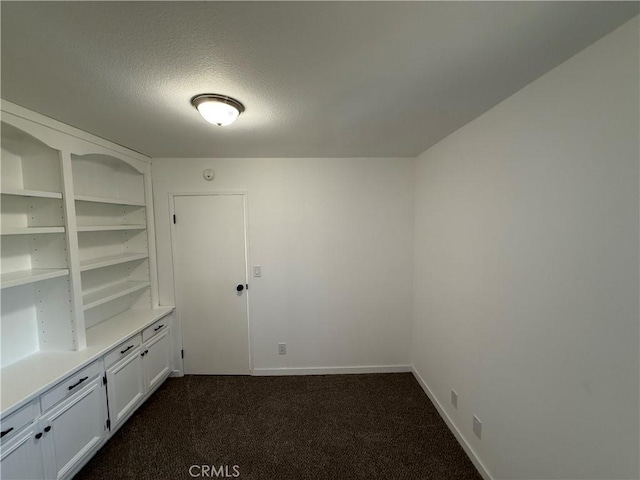 2440 Amelgado Dr, Hacienda Heights, CA 91745 - unfurnished room with baseboards, dark carpet, and a textured ceiling