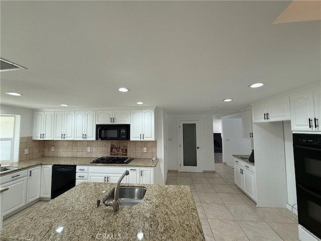 2440 Amelgado Dr, Hacienda Heights, CA 91745 - kitchen with light stone countertops, black appliances, and a sink