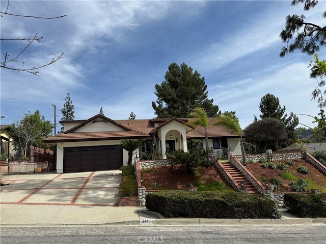 2440 Amelgado Dr, Hacienda Heights, CA 91745 - view of front of home with fence, a tiled roof, stairs, a garage, and driveway