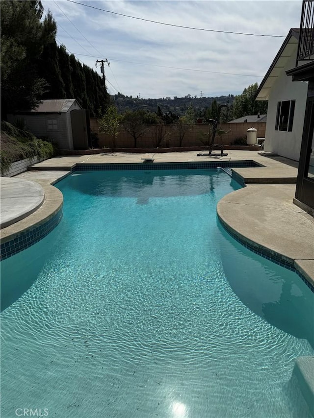 2440 Amelgado Dr, Hacienda Heights, CA 91745 - outdoor pool with a patio, an outbuilding, a fenced backyard, and a shed