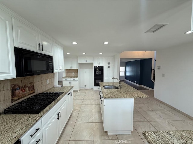 2440 Amelgado Dr, Hacienda Heights, CA 91745 - kitchen with tasteful backsplash, visible vents, light stone counters, black appliances, and a sink