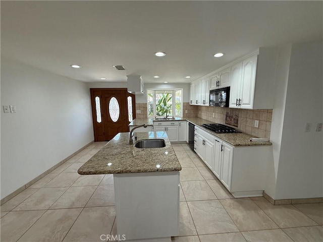 2440 Amelgado Dr, Hacienda Heights, CA 91745 - kitchen featuring light stone counters, backsplash, black appliances, and a sink