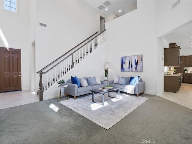 living area featuring light colored carpet and visible vents